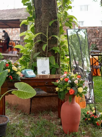 A charming little corner we created for guests to leave audio messages, featuring a vintage telephone and rustic floral decor.