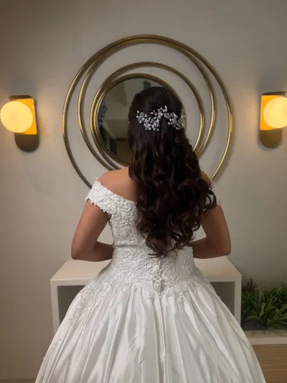The back view of this white wedding hairstyle, showcasing the long, flowing curls that look stunning with a cathedral veil.