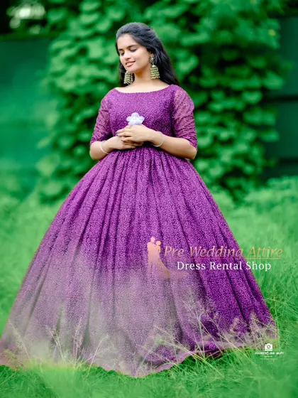 A beautiful outdoor portrait in the purple lace ball gown, with the green foliage making the color of the dress stand out.