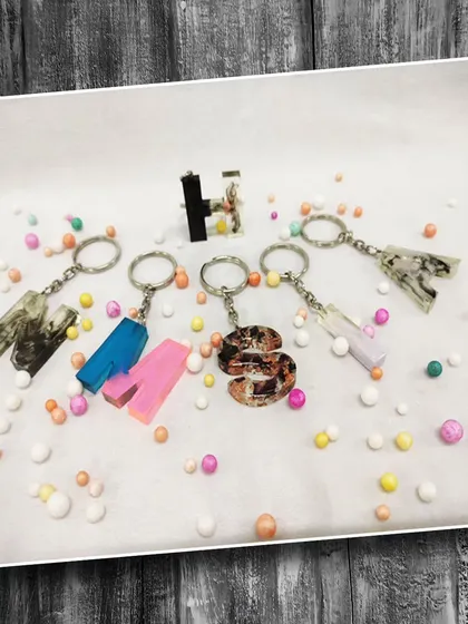 Custom initial keychains made with resin. These make for perfect personalized gifts, and we teach you how to make them in our craft workshops.