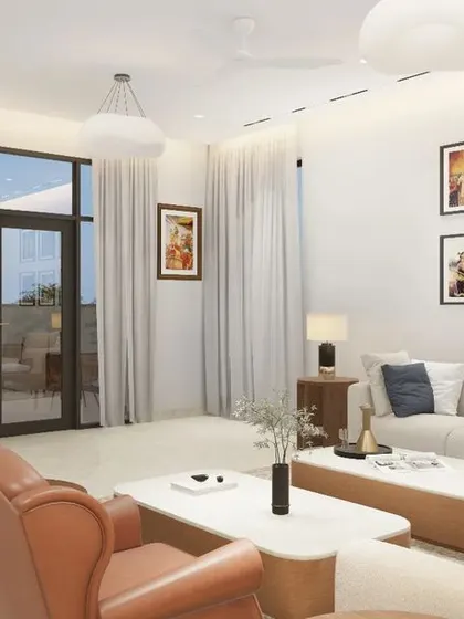 This bright and airy living room is designed for comfort and personal expression. A plush sectional sofa is paired with classic leather armchairs, while a gallery wall of family photos adds a warm, personal touch.