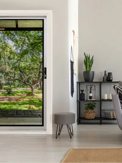 A TENTUFF hinged security door enhances this living space, allowing natural light and a view of the garden to become part of the room's decor. This is how we combine home security with interior design, ensuring your safe space is also a beautiful one.
