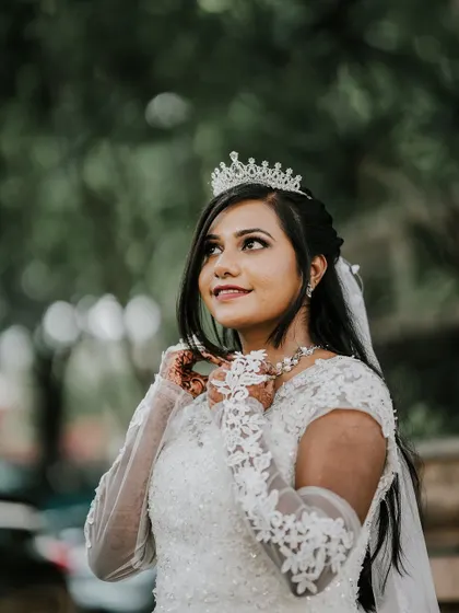 A candid-style portrait of the Christian bride, looking up with a hopeful and happy expression.