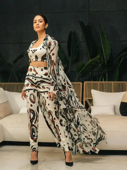 A powerful, centered pose from the same shoot, showcasing the full outfit with a confident and commanding presence.