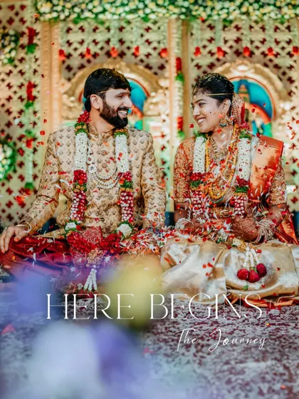 'Here Begins The Journey'. The couple sits amidst a shower of petals, a perfect shot to mark the beginning of their life together.