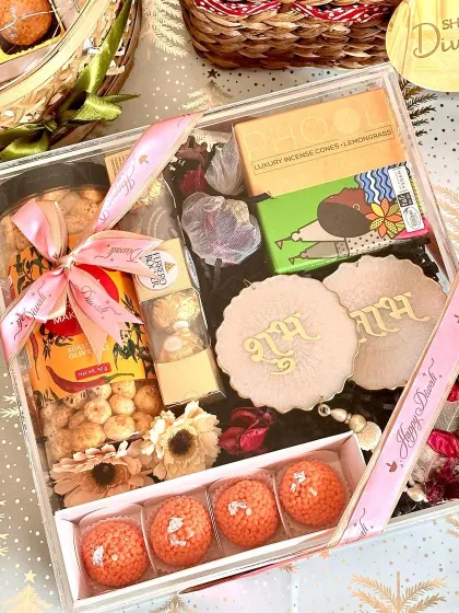 A beautiful shot of our acrylic Diwali hamper, with the festive lights creating a warm, celebratory glow.
