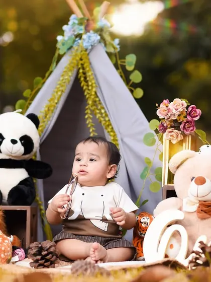 This little one is surrounded by his furry friends in our outdoor teepee setup. The warm, golden light of the park makes these photos feel magical.