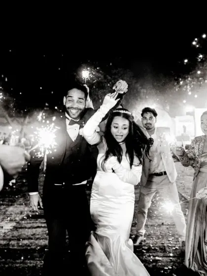 A magical exit under a tunnel of sparklers. This black and white photo captures the joy and celebration of the moment perfectly.