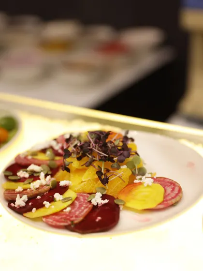 A vibrant beetroot and citrus salad, garnished with feta cheese and pumpkin seeds. This colourful and healthy dish is a beautiful addition to any buffet spread, offering a refreshing counterpoint to richer dishes.