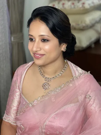 A beautiful, smiling portrait, showcasing the fresh and radiant makeup that enhances her natural features.