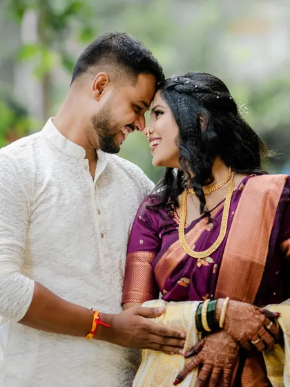 A close, happy portrait of a couple touching foreheads and smiling. This candid moment perfectly captures the excitement and love of being newly engaged.