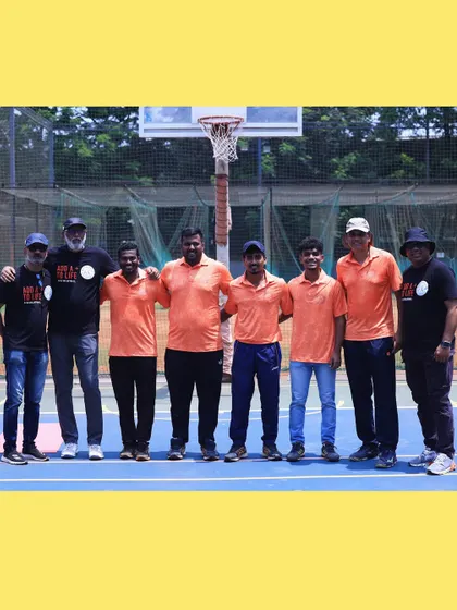 Our coaching staff taking a moment together on the court. The bond between our coaches is the foundation of our academy's leadership.