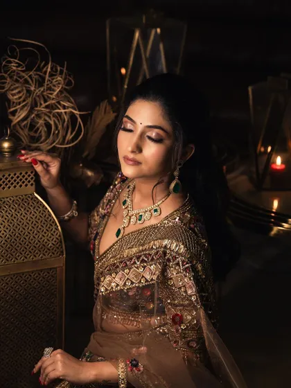 A soft, glamorous look created with one of my Polki and emerald sets. The deep colors of the stones stand out beautifully against the bronze outfit, making it an excellent choice for an evening reception or sangeet.