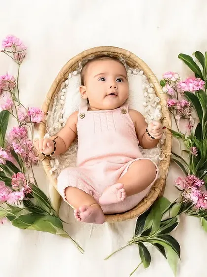 A beautiful newborn-style portrait surrounded by fresh pink flowers. I use simple, natural props to highlight the delicate features and peaceful nature of your baby.
