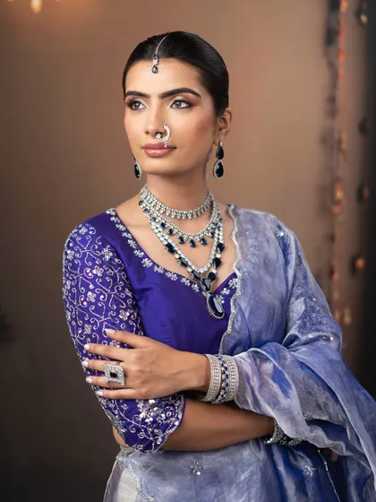 This look showcases how to pair bold colors like royal blue with elegant, radiant makeup for a balanced and beautiful result.