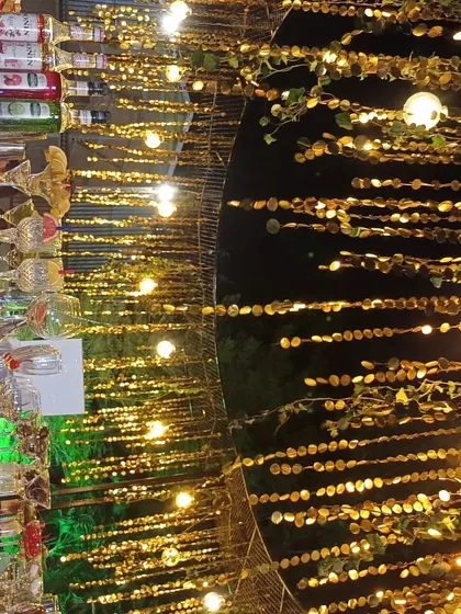 A detailed shot of the bar at a wedding, with golden decor elements and sparkling lights creating a warm and celebratory atmosphere.