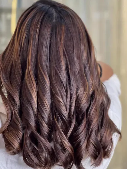 Another shot of the rich brown and gold curls, showing off their bounce and shine.