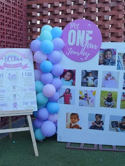 A personalized milestone and welcome board area for a unicorn-themed party.