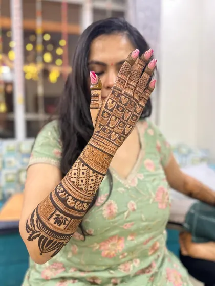 A side view of the bridal back-hand design, with a lotus cuff at the wrist.