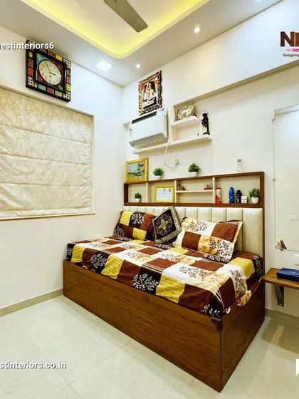 A bedroom from another completed project, featuring a bed with built-in headboard shelving for books and decor. The design is practical, making good use of vertical space.