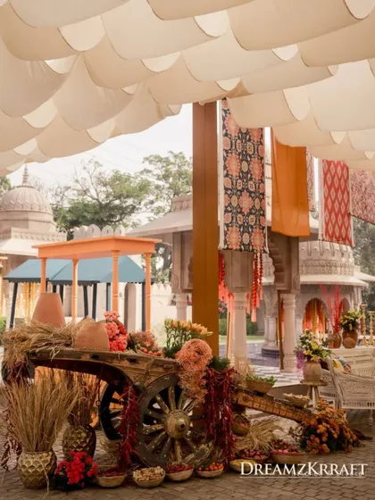 Another rustic cart, this time filled with flowers and pottery, enhances the traditional marketplace ambiance.