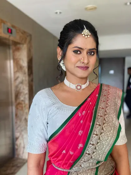A happy portrait of the bride, showcasing her glowing skin and the delicate details of her makeup and hair.