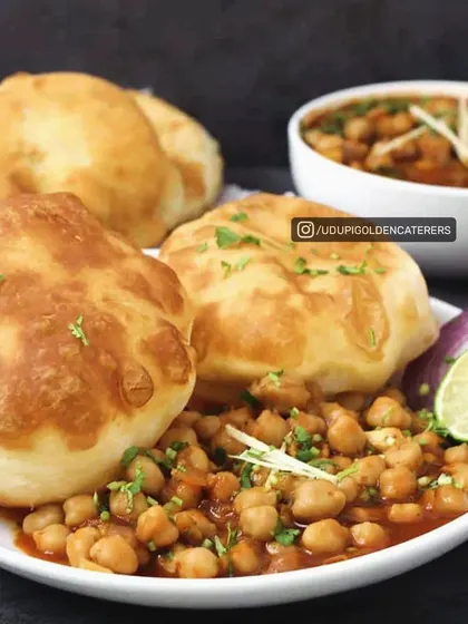 A classic North Indian favorite, our Chole Bhature features fluffy, deep-fried bread served with a hearty and spicy chickpea curry. It is a perfect main course for any festive occasion.