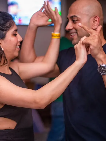 A playful and fun moment, with the lead dancer pointing with a smile.