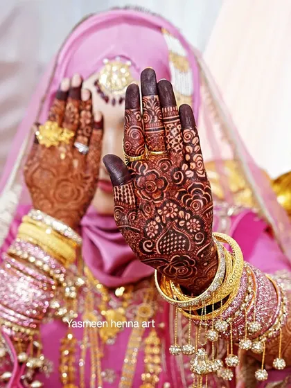 This is the moment it all comes together. Seeing my bride Afra, radiant in her full wedding attire with her dark mehndi stain and jewelry, is the most rewarding part of my work.