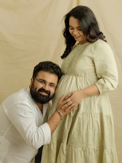 "I can't wait to meet you." This classic pose of a partner listening to the baby bump is always so sweet and full of anticipation. A beautiful memory from your casual studio session.