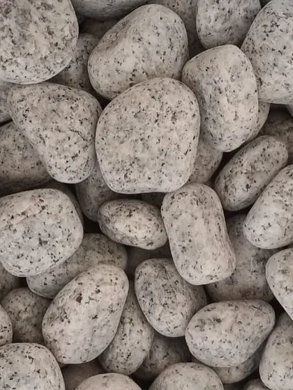 A close-up of my unpolished white granite pebbles. These are great for pathways, borders, or as a mulch alternative.