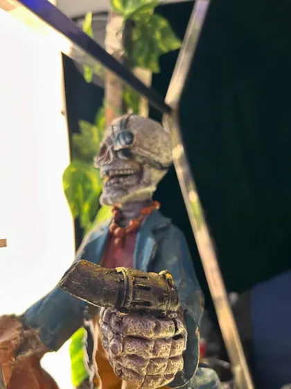 A close-up of a skeleton figurine with a grenade, showcasing our commitment to detailed and edgy themed decor.