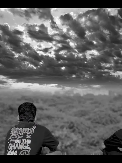 A powerful, symbolic still from the 'Kurbaan Hua' music video. This shot of two figures looking out over the clouds represents memory, loss, and the spiritual journey of the song.