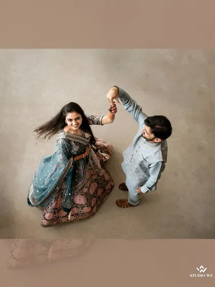 An aerial shot of a couple dancing, showcasing a unique perspective that adds a creative touch to their engagement photos.