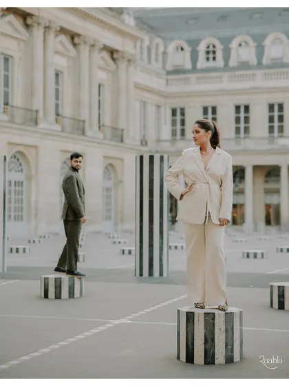 An editorial shot at the Palais Royal in Paris, using the iconic striped columns to create a visually striking and modern pre-wedding portrait.