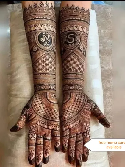 A romantic bridal design featuring the couple's initials, 'N' and 'S', inside hearts. This is a popular way to personalize your wedding mehndi.