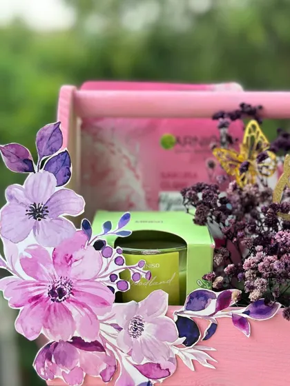 A close-up of the floral details on my pink grooming hamper. The watercolor-style flower cutouts and delicate butterflies add a touch of elegance to this self-care package.