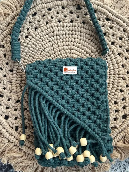 A stylish small handbag in a lovely green shade, finished with wooden beads for that earthy, bohemian feel.