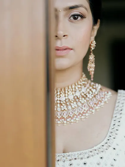 A creative and intimate portrait of the bride, Jui, her face partially hidden, drawing focus to her eyes and stunning necklace.