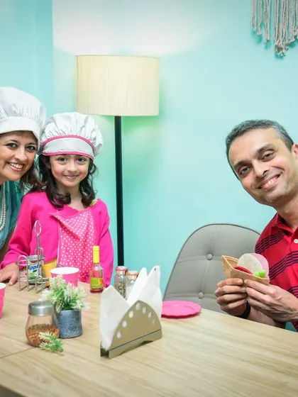 Little chefs in the house! A family enjoys some quality time together in our pretend play cafe area.