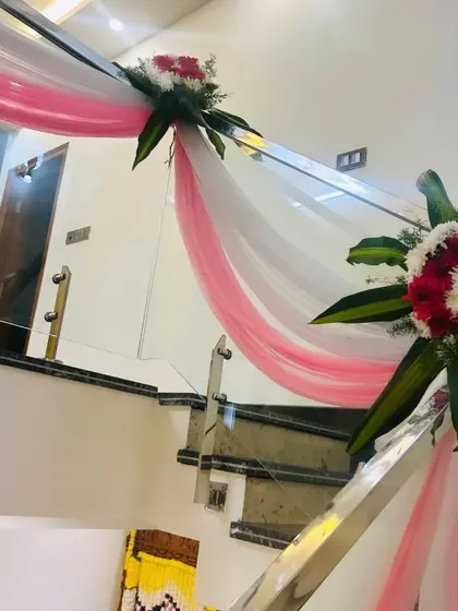 Another view of the staircase decor, showing how the drapes and flowers flow down the railing.