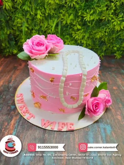 A beautiful pink cake for a "Sweet Wife". Decorated with fresh roses and an edible pearl necklace, it's an elegant and loving gesture.