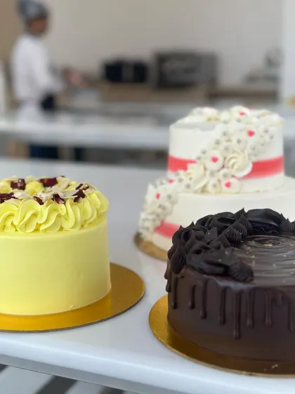 A trio of stunning cakes from our 5-day workshop. Each cake showcases a different technique: a chocolate drip, a Rasmalai fusion flavor, and an elegant two-tiered design, reflecting the comprehensive curriculum.