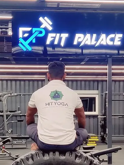 A duplicate of the meditative pose from behind, emphasizing focus amidst the gym equipment.