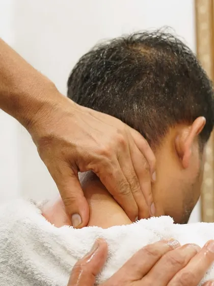 A close-up of my neck and shoulder massage technique. This is a crucial part of my relaxation services, targeting the areas where men commonly hold stress and tension.