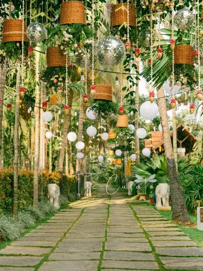 This shot captures the full length of the decorated pathway, creating a sense of anticipation and wonder as guests make their way to the ceremony.