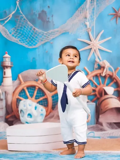 Ready to set sail on an adventure. This full-body shot shows the little sailor standing in his boat, ready for his imaginative journey in my studio.