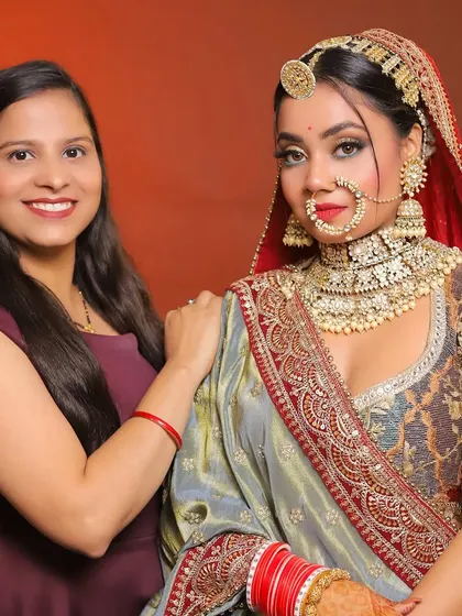 My student standing proudly next to her creation. This is a very regal and intricate bridal look that she has executed flawlessly.