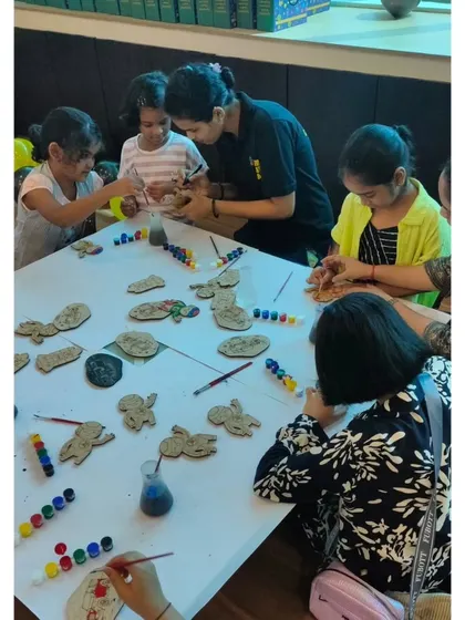 A table full of kids and parents engaged in painting. We provide a wide range of colors and all the necessary supplies for this popular and relaxing activity.