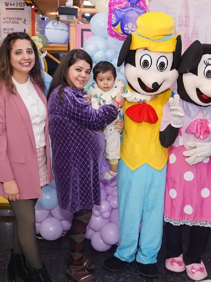 Mickey and Minnie Mouse mascots join the party for photos with the guests, bringing classic Disney magic to the celebration.